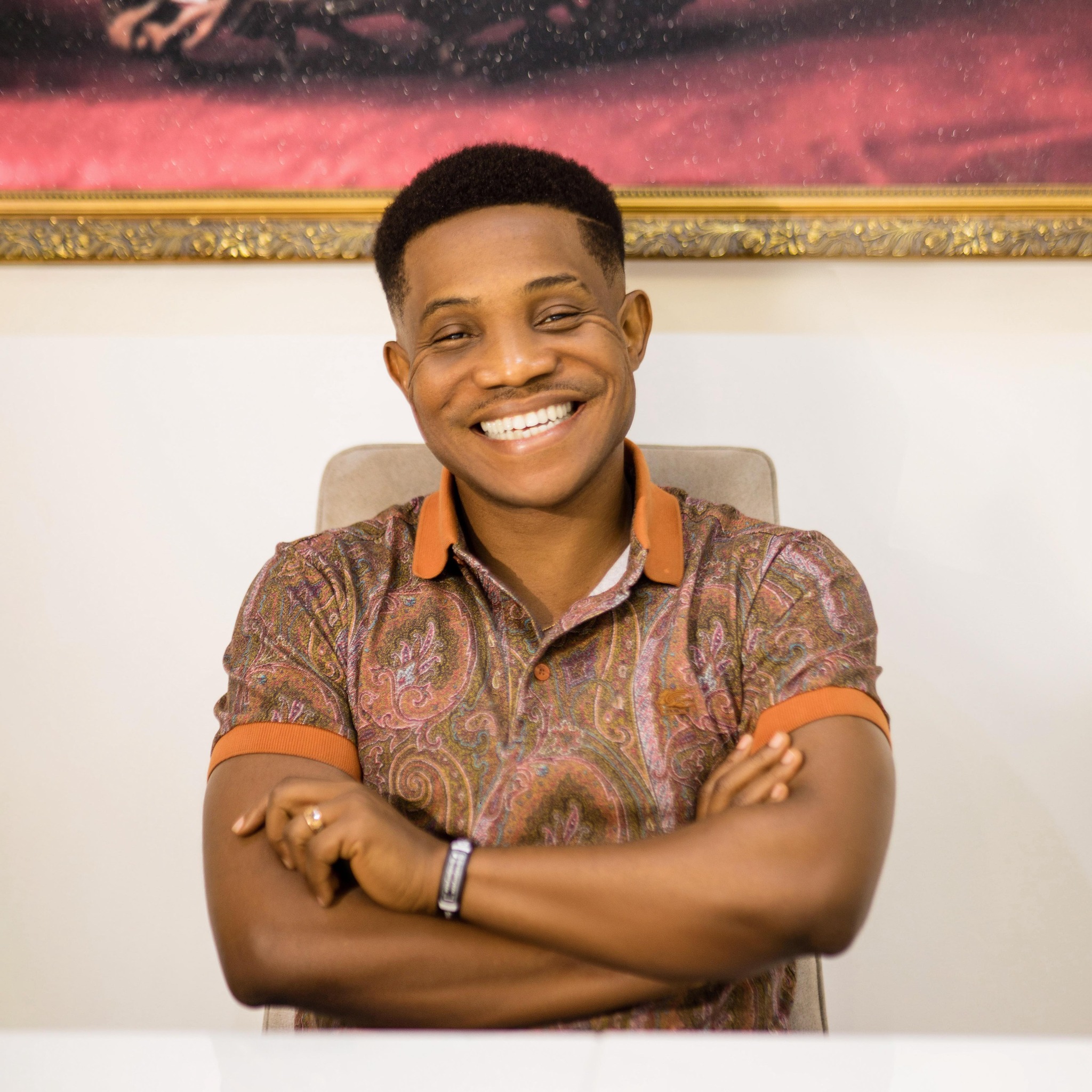 Pastor Jerry Eze smiling with arms folded