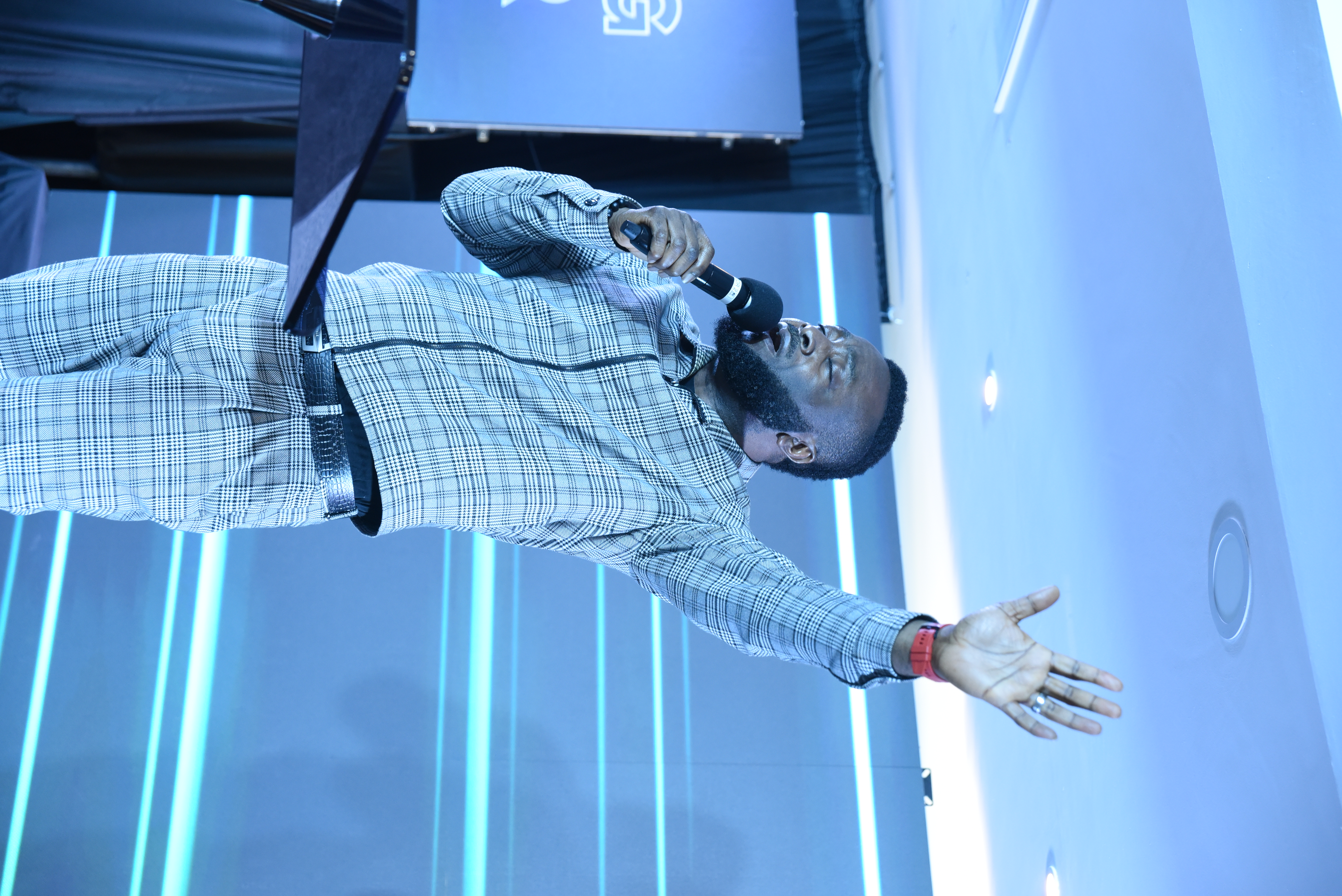 Pastor Phreddy preaching with his hand raised